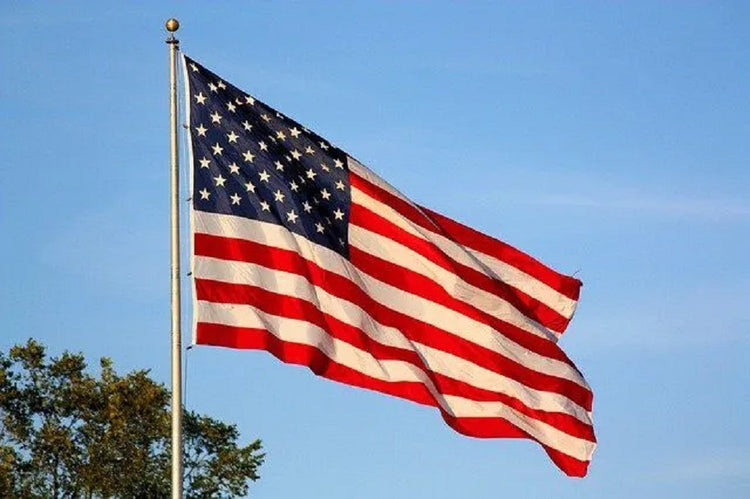 An American flag flying on a flagpole.