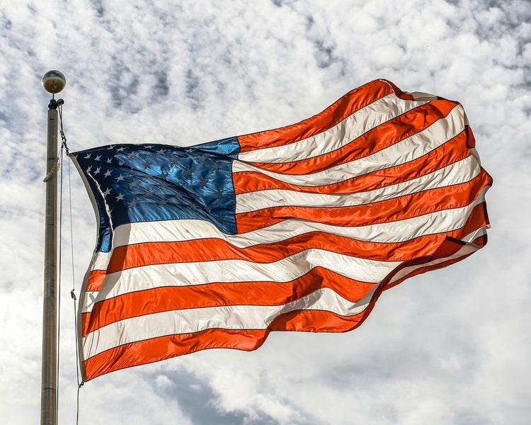 An American flag flying on a flagpole.