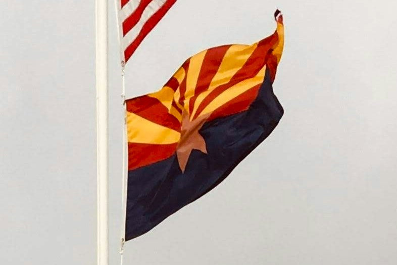 The flag of Arizona flying from a flagpole.